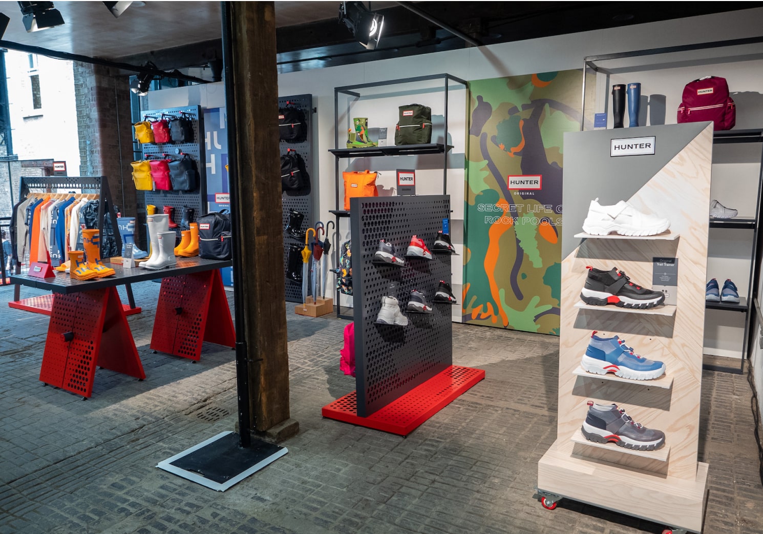 A variety of shoe displays in a retailer, freestanding and fixed retail shelving