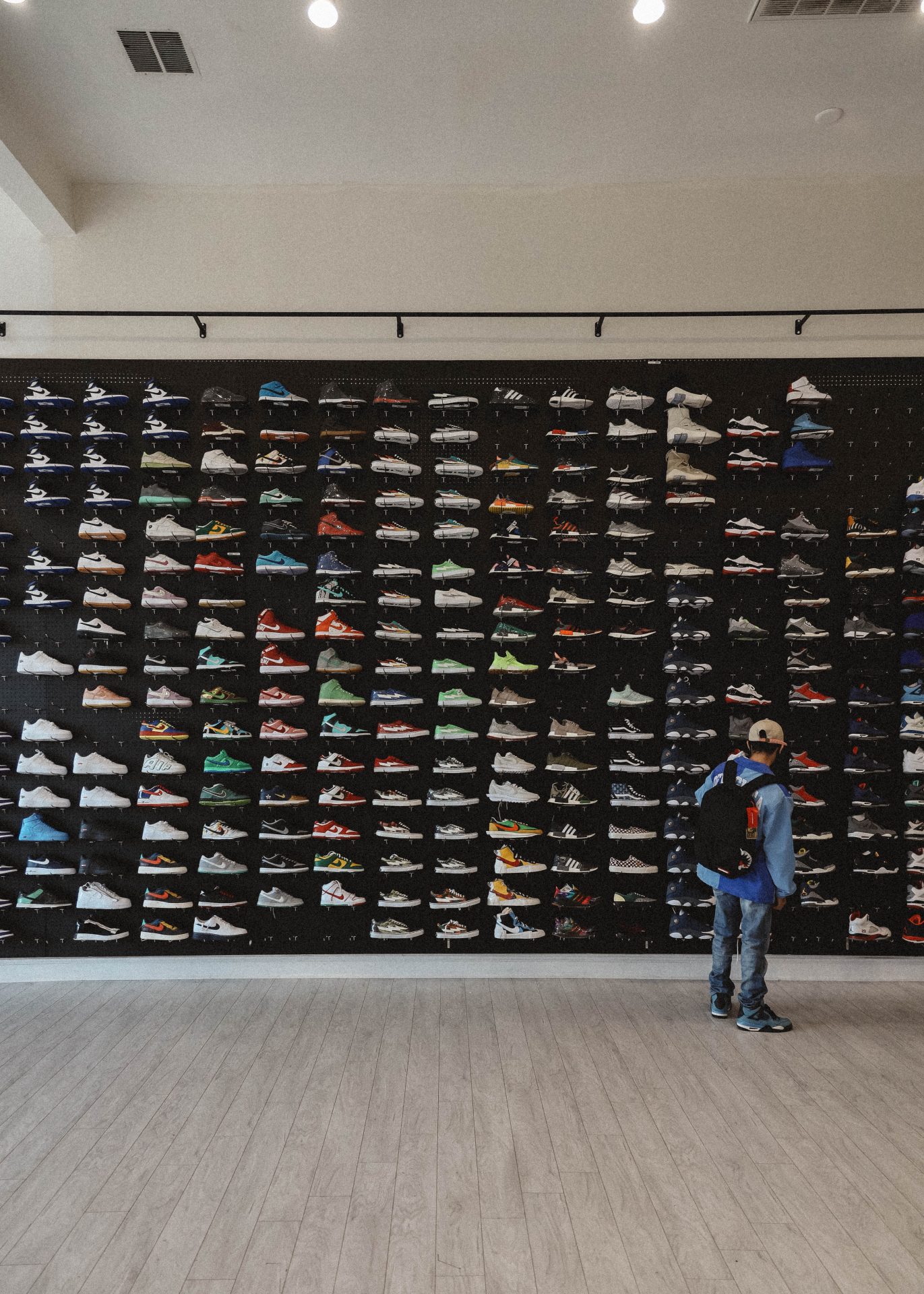 A wall display of shoes on floating shelves