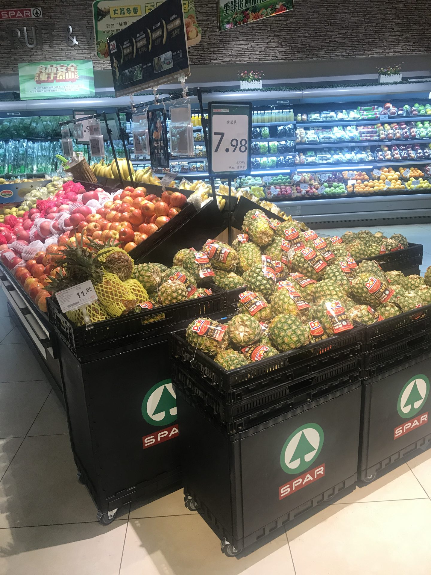 Branded produce displays with company logo. 